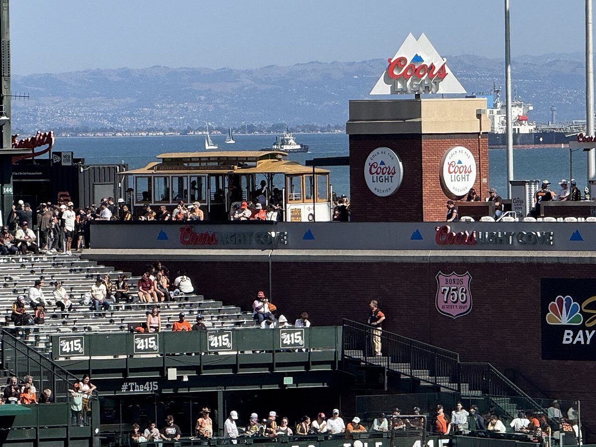 fans filling the stands at Oracle Park with McCovey Cove in the background