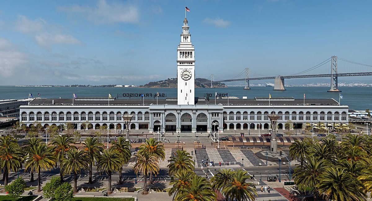 Ferry Building marketplace exterior with Bay Bridge visible across the water