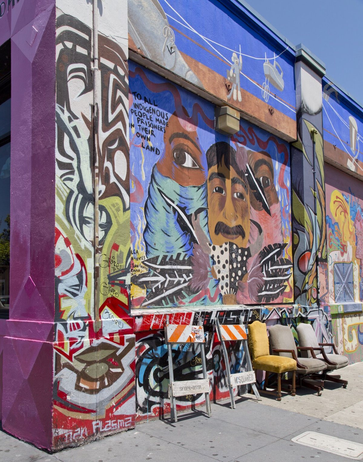 A Mission District garage door covered in a large community mural